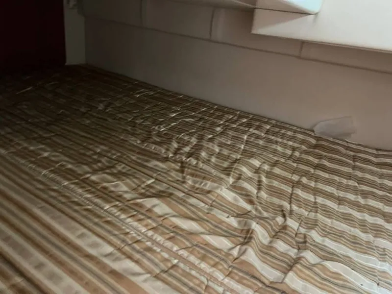Slide: The Image of Interior of 2011 Monterey 260 SCR with striped bedding. - 17