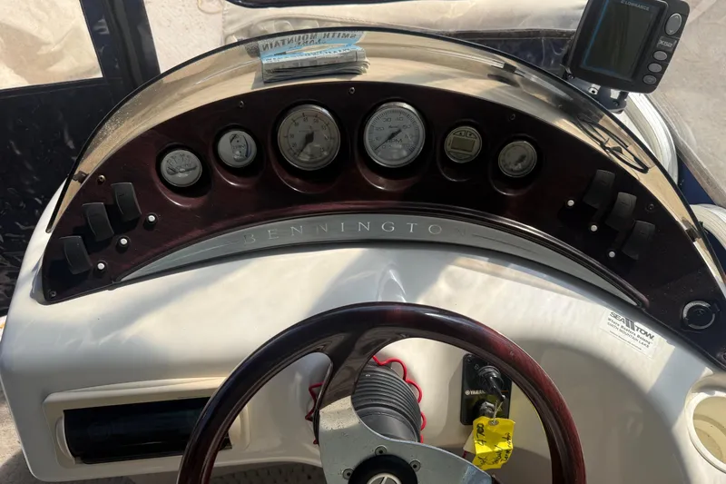 Slide: The Image of Dashboard of a 2005 Bennington 2575RL boat with gauges and controls. - 11