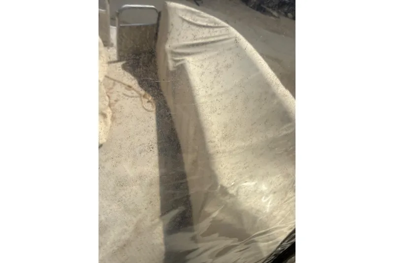 Slide: The Image of Covered 2005 Bennington 2575RL boat with protective tarp in storage. - 13
