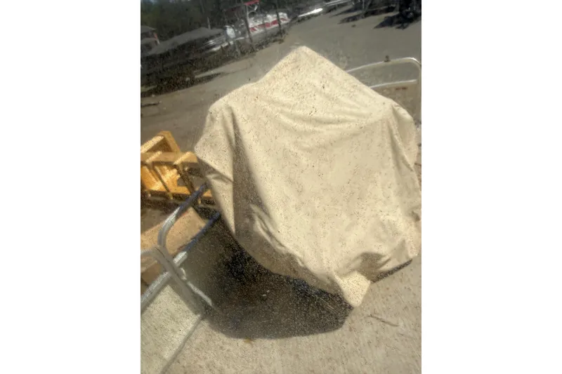 Slide: The Image of Covered 2005 Bennington 2575RL boat on a sunny day, partially visible under tarp. - 14