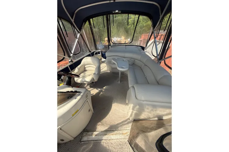 Slide: The Image of Interior of a 2005 Bennington 2575RL boat with seating and steering area. - 20