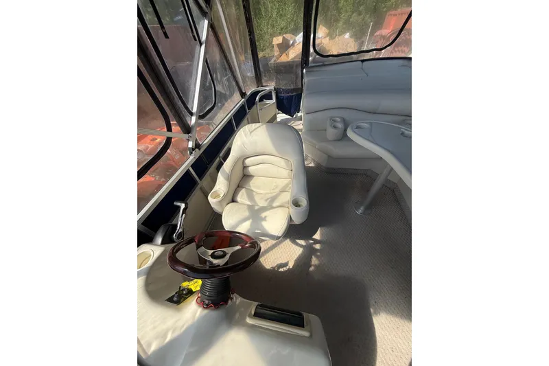 Slide: The Image of Interior of a 2005 Bennington 2575RL boat with steering wheel and seating. - 22
