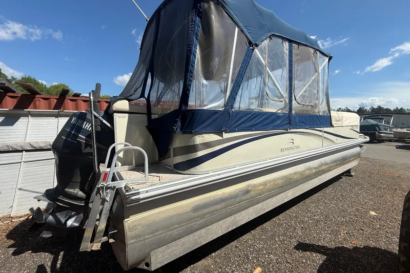 Slide: The Image of 2005 Bennington 2575RL pontoon boat with blue canopy and Yamaha outboard motor. - 5