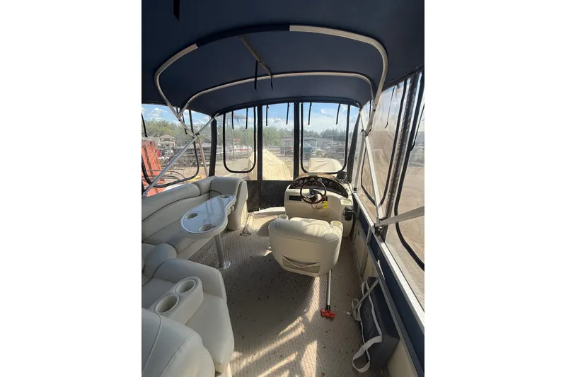 Slide: The Image of Interior of a 2005 Bennington 2575RL pontoon boat with seating and steering console. - 8
