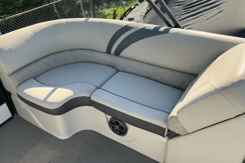 Slide: The Image of 2019 Crest Classic 230 SLC boat interior with gray cushioned seating. - 11