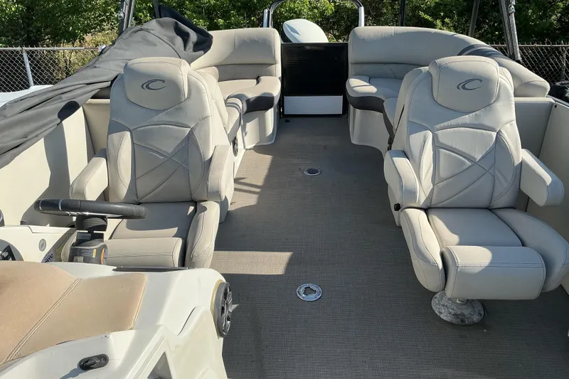 Slide: The Image of 2019 Crest Classic 230 SLC boat interior with plush seating and steering console. - 12
