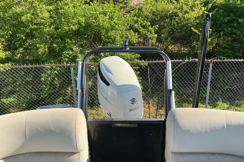 Slide: The Image of 2019 Crest Classic 230 SLC boat with Suzuki 300 outboard motor, parked near greenery. - 14