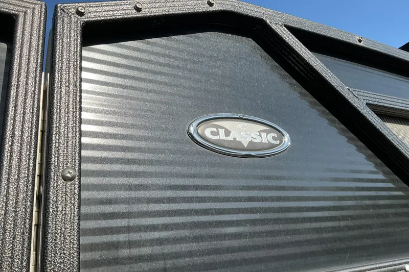Slide: The Image of 2019 Crest Classic 230 SLC boat panel with logo, textured surface, and blue sky background. - 15