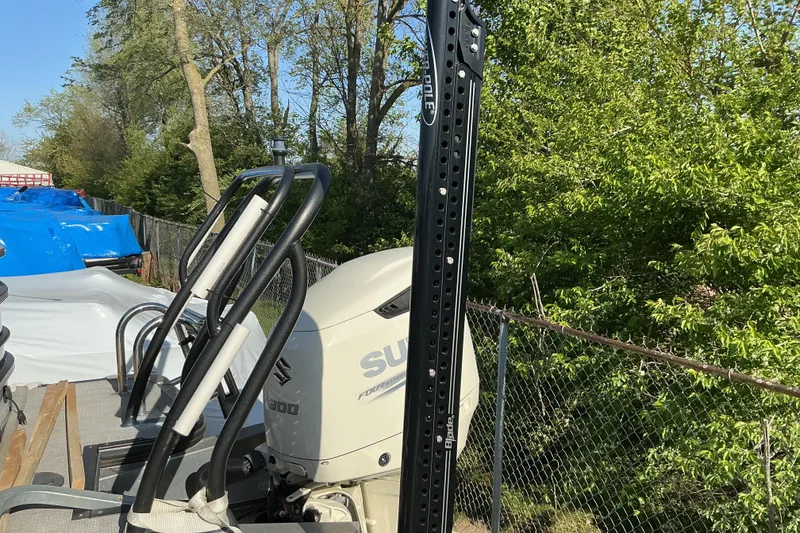 Slide: The Image of 2019 Crest Classic 230 SLC boat with Suzuki outboard motor, parked near trees. - 5