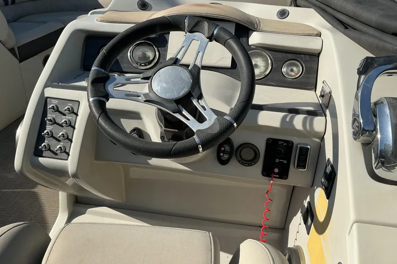 Slide: The Image of Steering console of a 2019 Crest Classic 230 SLC boat with gauges and controls. - 6