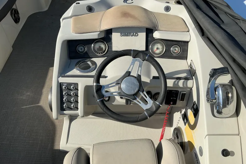 Slide: The Image of Steering console of 2019 Crest Classic 230 SLC boat with Simrad electronics. - 8