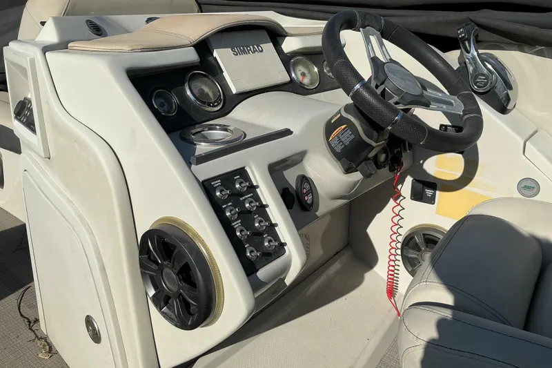 Slide: The Image of Cockpit of 2019 Crest Classic 230 SLC boat with steering wheel and control panel. - 9