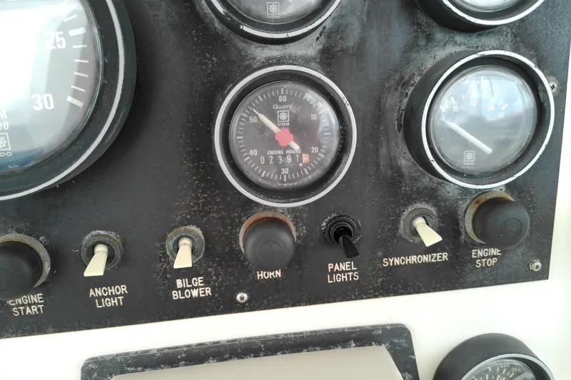 Slide: The Image of Control panel of a 1986 Viking 44 Motor Yacht with gauges and switches. - 14