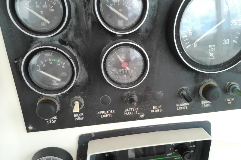 Slide: The Image of Control panel of a 1986 Viking 44 Motor Yacht with gauges and switches. - 15
