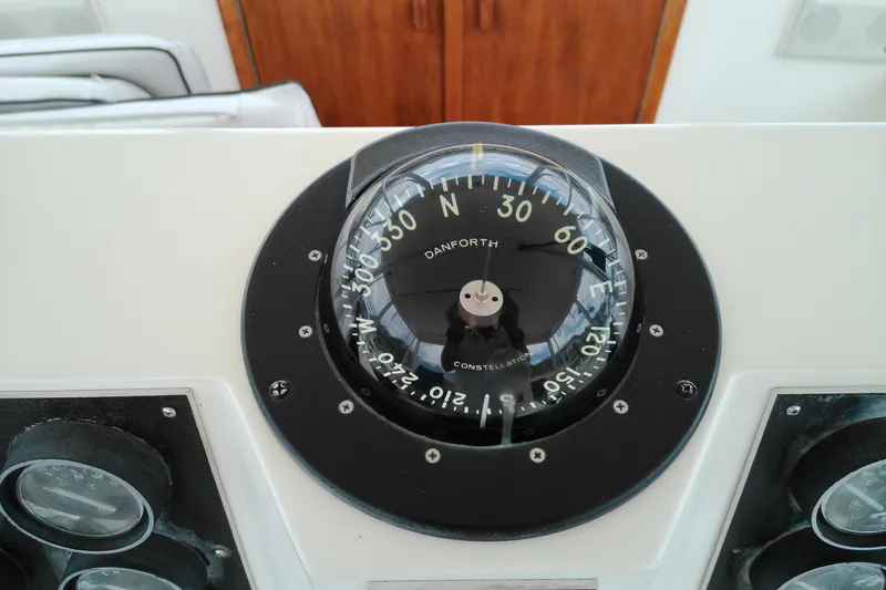 Slide: The Image of Compass on 1986 Viking 44 Motor Yacht dashboard, displaying navigation directions. - 16