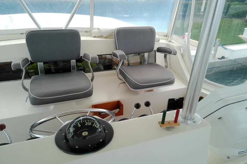 Slide: The Image of Interior helm of 1986 Viking 44 Motor Yacht with dual seats and navigation instruments. - 19
