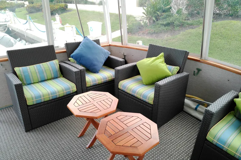 Slide: The Image of Cozy seating area on 1986 Viking 44 Motor Yacht with wicker chairs and colorful cushions. - 2