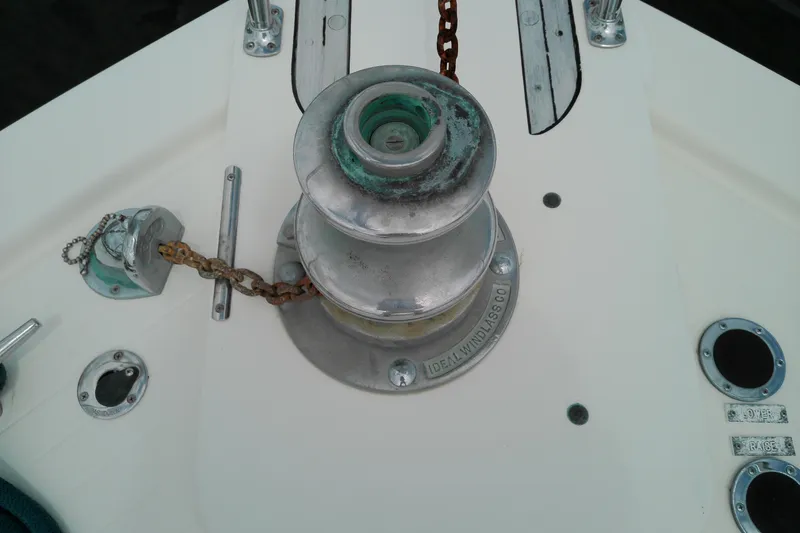 Slide: The Image of Anchor windlass on 1986 Viking 44 Motor Yacht deck, featuring chain and metal fittings. - 24