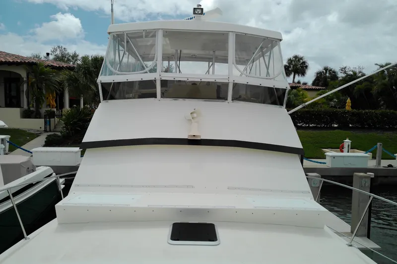 Slide: The Image of 1986 Viking 44 Motor Yacht docked, showcasing its sleek design and spacious upper deck. - 25