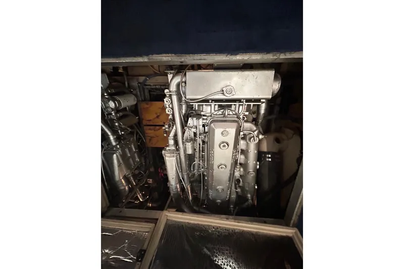 Slide: The Image of Engine compartment of a 1986 Viking 44 Motor Yacht, showcasing mechanical components. - 29