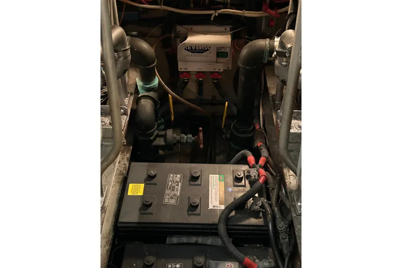 Slide: The Image of Engine room of 1986 Viking 44 Motor Yacht with batteries and Reverso pump system. - 31