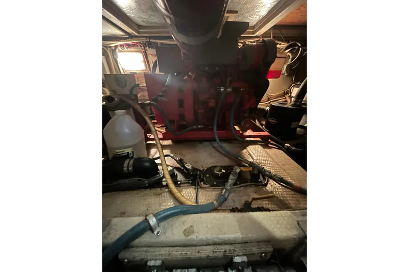Slide: The Image of Engine room of a 1986 Viking 44 Motor Yacht with visible hoses and equipment. - 32