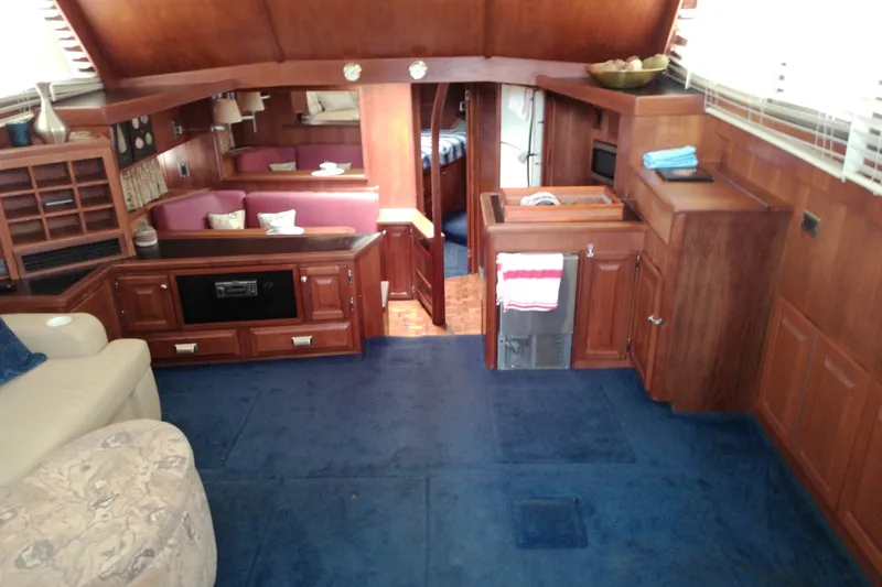 Slide: The Image of Interior of 1986 Viking 44 Motor Yacht with wood paneling and blue carpet. - 35