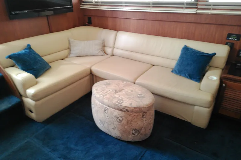 Slide: The Image of Interior of 1986 Viking 44 Motor Yacht with beige sofa and blue cushions. - 36