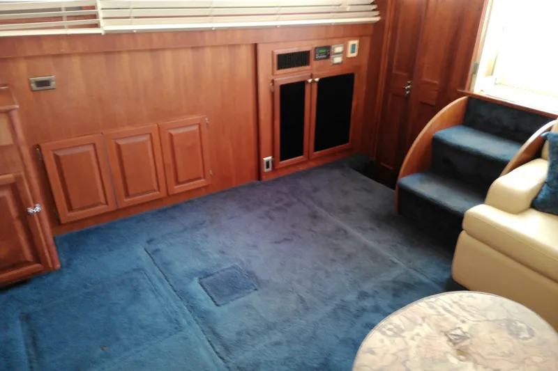 Slide: The Image of Interior of 1986 Viking 44 Motor Yacht with blue carpet and wooden cabinetry. - 37