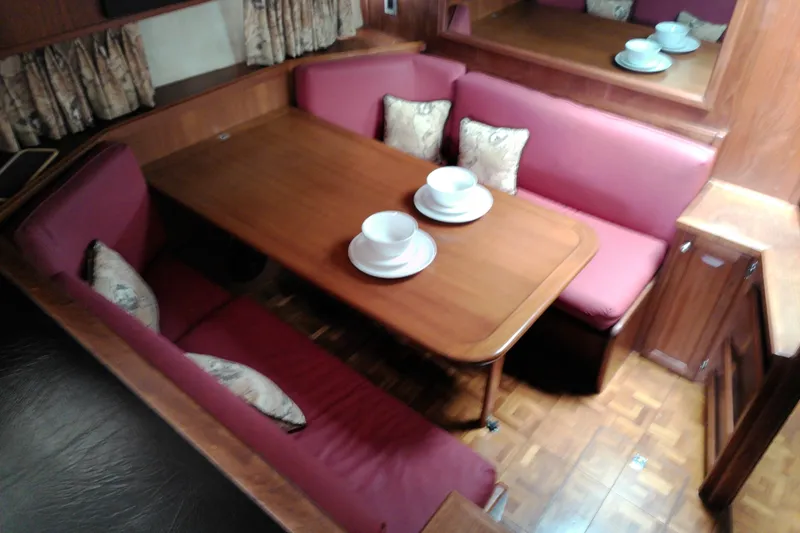 Slide: The Image of Interior of 1986 Viking 44 Motor Yacht with dining area and red seating. - 39