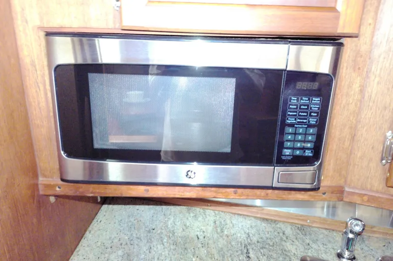 Slide: The Image of Microwave in 1986 Viking 44 Motor Yacht kitchen with wooden cabinetry. - 43