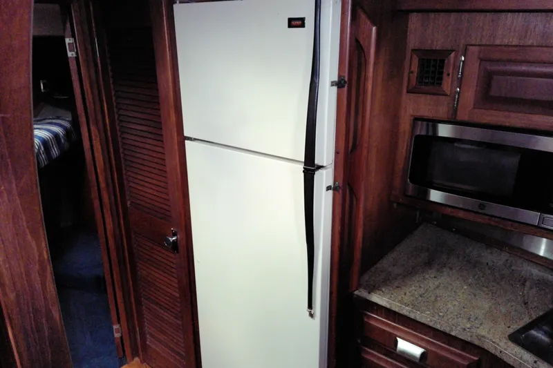 Slide: The Image of Interior of 1986 Viking 44 Motor Yacht kitchen with fridge and microwave. - 45
