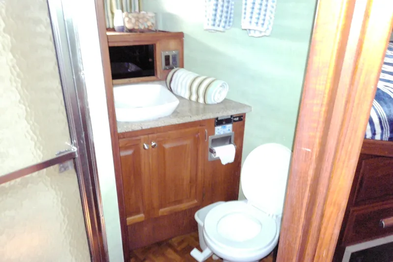 Slide: The Image of Bathroom interior of 1986 Viking 44 Motor Yacht with sink, toilet, and shower. - 46