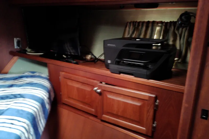 Slide: The Image of Interior of 1986 Viking 44 Motor Yacht with printer and striped bedding. - 49