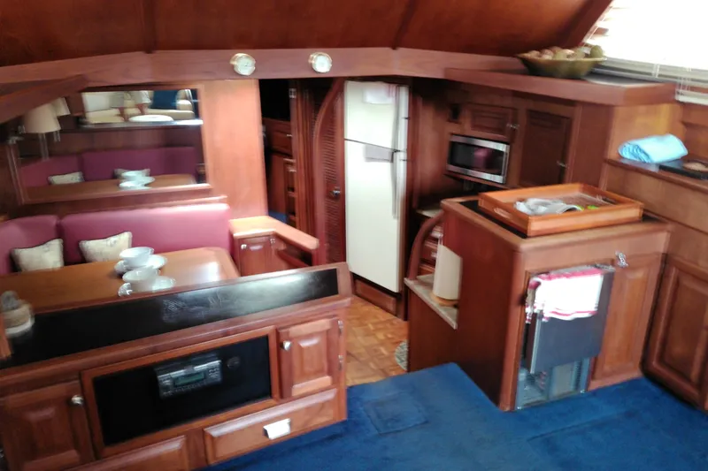 Slide: The Image of Interior of a 1986 Viking 44 Motor Yacht with wood cabinetry and dining area. - 54