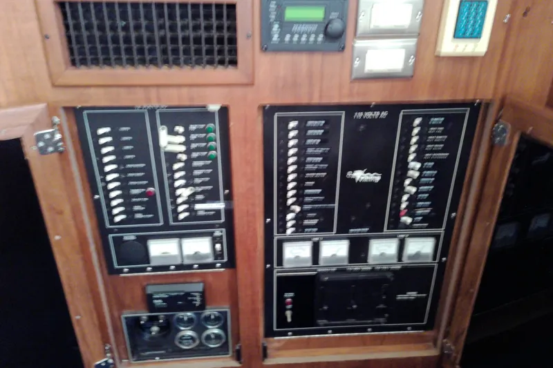 Slide: The Image of Electrical control panel of a 1986 Viking 44 Motor Yacht, featuring switches and gauges. - 55