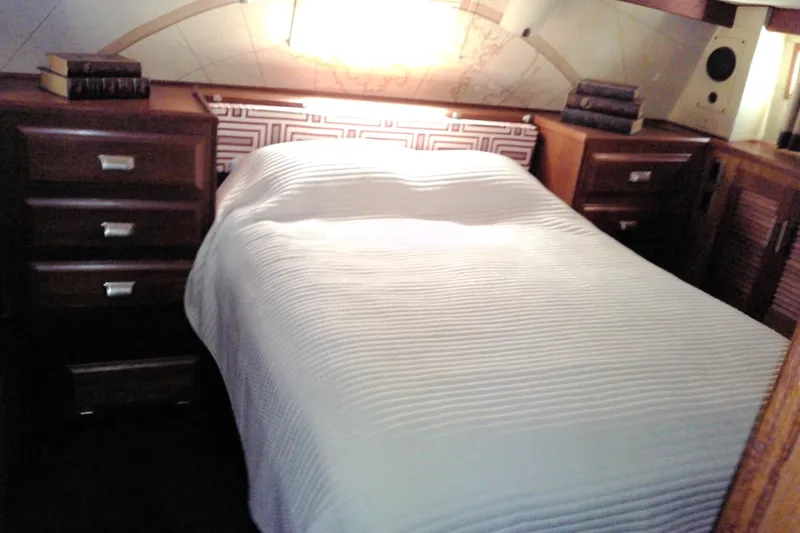 Slide: The Image of Cozy bedroom interior of 1986 Viking 44 Motor Yacht with wooden cabinets and soft lighting. - 57