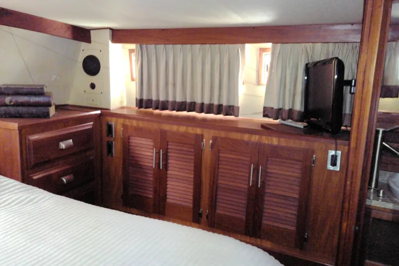 Slide: The Image of Interior of 1986 Viking 44 Motor Yacht with wooden cabinetry and small TV. - 58
