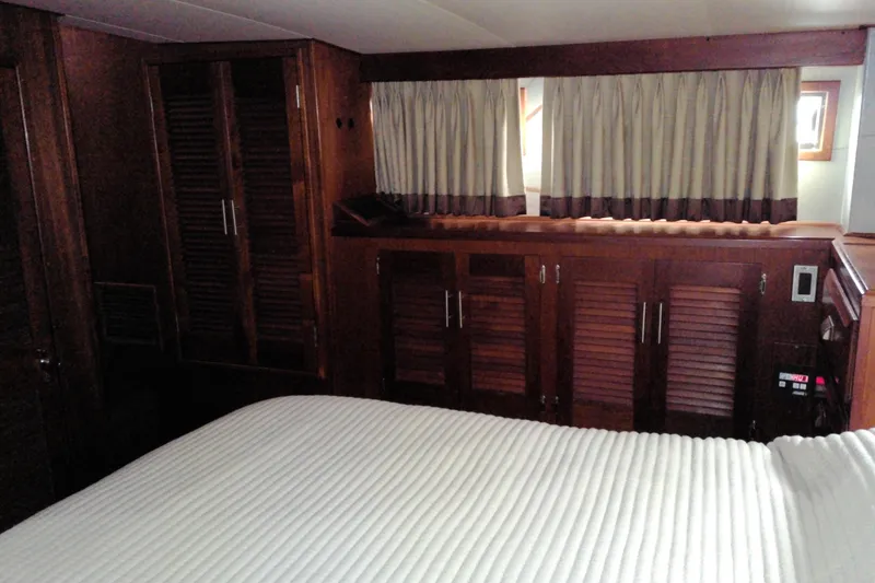 Slide: The Image of Interior cabin of 1986 Viking 44 Motor Yacht with wood paneling and curtains. - 60