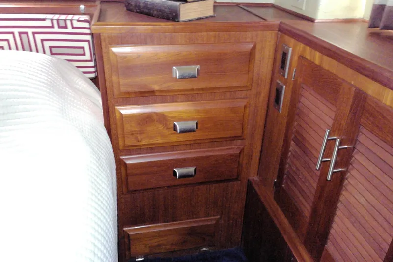 Slide: The Image of Wooden cabinetry inside a 1986 Viking 44 Motor Yacht, featuring drawers and louvered doors. - 62