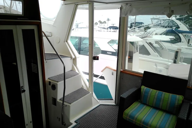 Slide: The Image of Interior view of 1986 Viking 44 Motor Yacht with marina backdrop. - 7