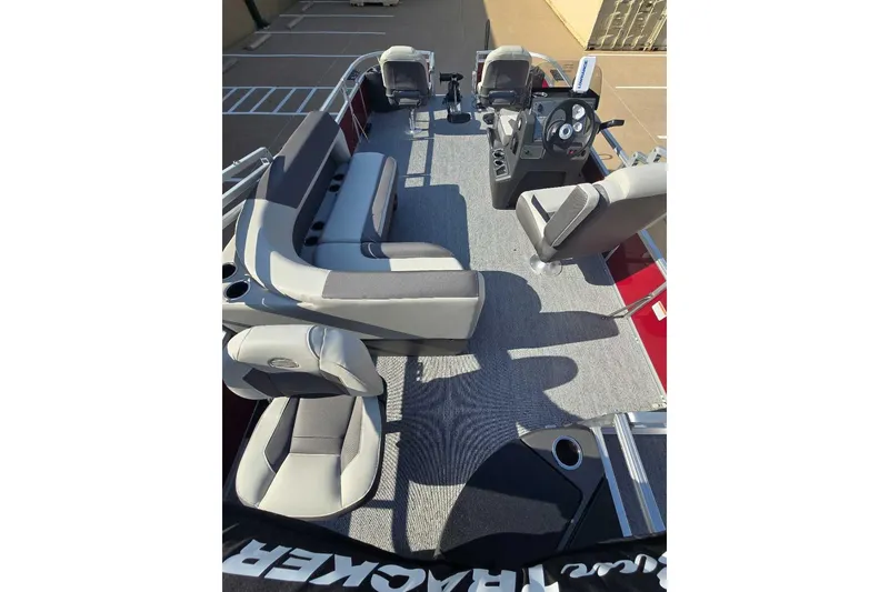 Slide: The Image of 2026 Sun Tracker Bass Buggy 18 DLX pontoon boat interior with seating and steering console. - 4