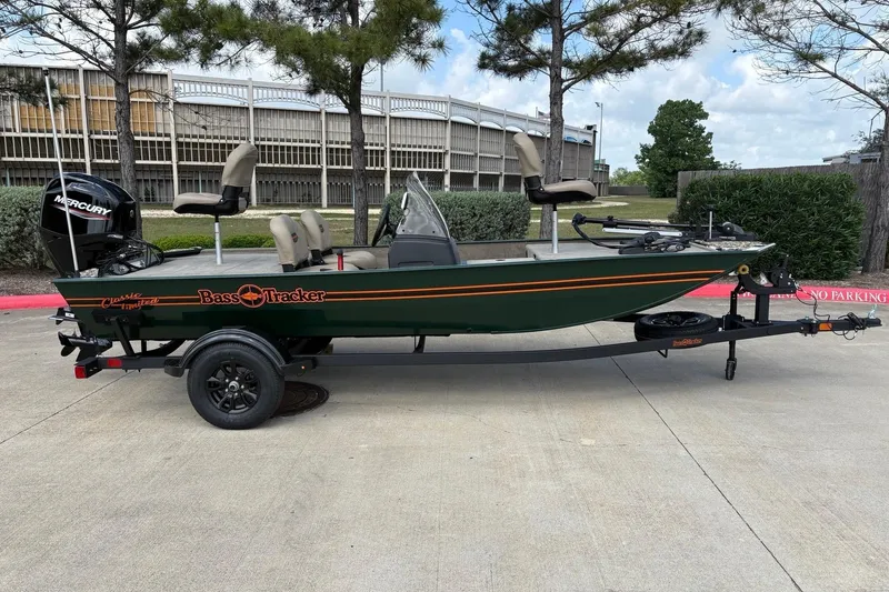 Slide: The Image of 2026 Tracker Bass Tracker Classic Limited boat on trailer, parked outdoors. - 2