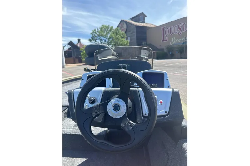 Slide: The Image of Steering console of 2026 Tracker Pro Team 190 boat under clear sky. - 6