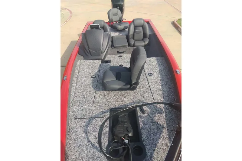 Slide: The Image of 2026 Tracker Pro Team 175 boat interior with gray carpet and black seats. - 8
