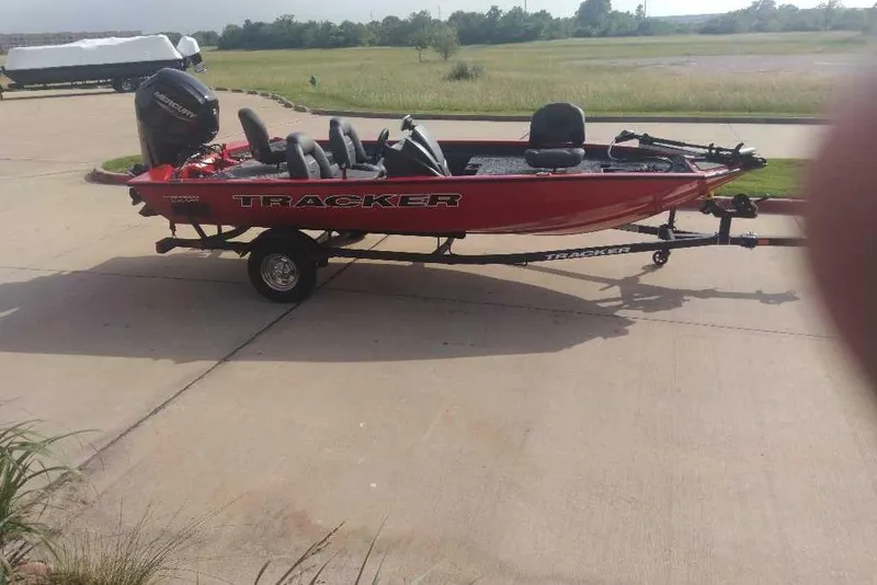 Slide: The Image of 2026 Tracker Pro Team 175 boat on trailer, parked on a driveway. - 6