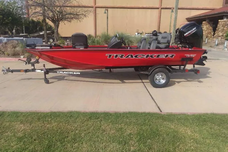 Slide: The Image of 2026 Tracker Pro Team 175 boat in vibrant red, parked on a trailer outdoors. - 5