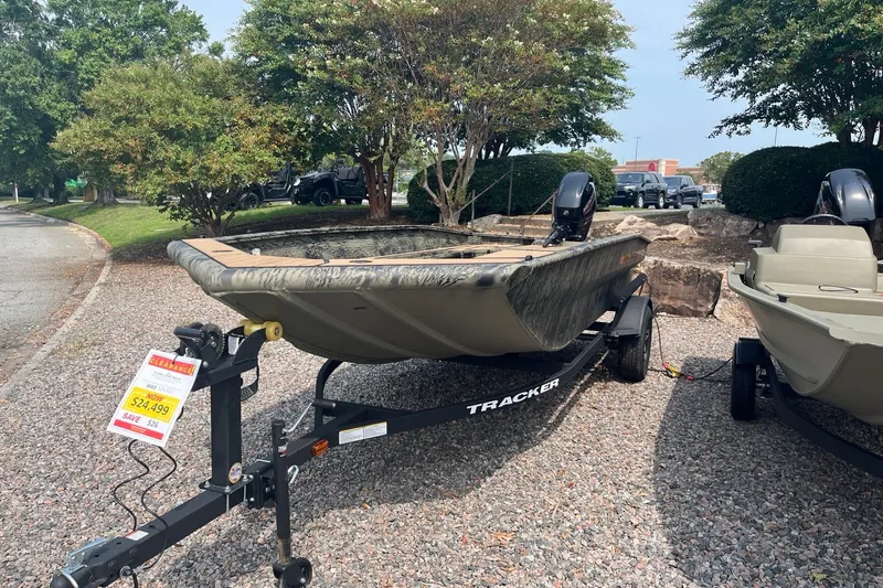Slide: The Image of 2026 Tracker Grizzly 1756 T Marsh boat on sale for $24,499, displayed outdoors. - 2
