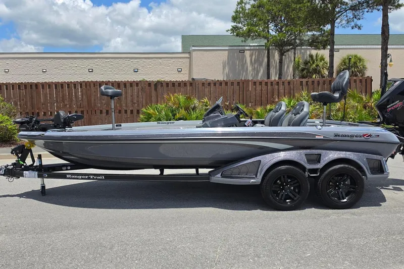 Slide: The Image of 2026 Ranger Z521R Cup-Equipped boat on trailer, parked outdoors under a cloudy sky. - 11