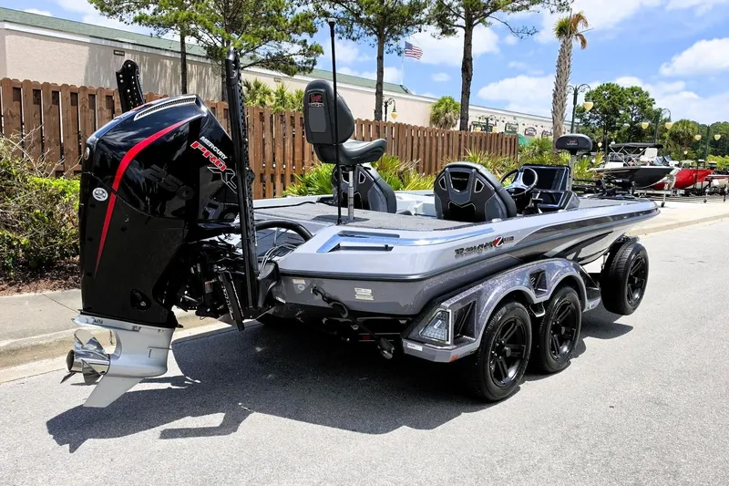 Slide: The Image of 2026 Ranger Z521R Cup-Equipped boat with powerful Mercury engine, parked outdoors. - 2
